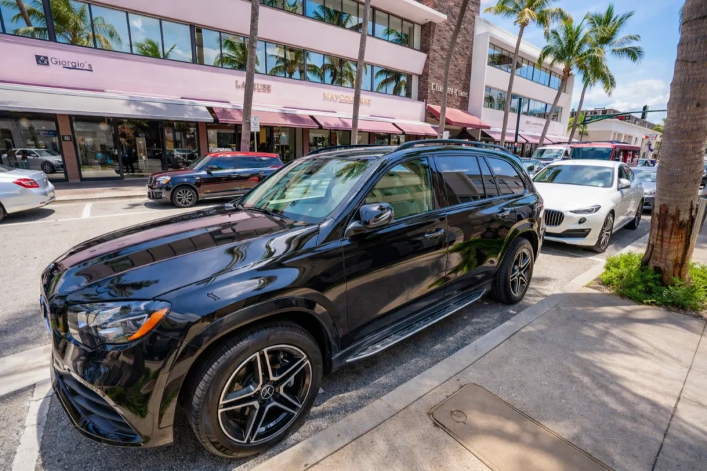 Luxury sedan parked outside a conference venue entrance