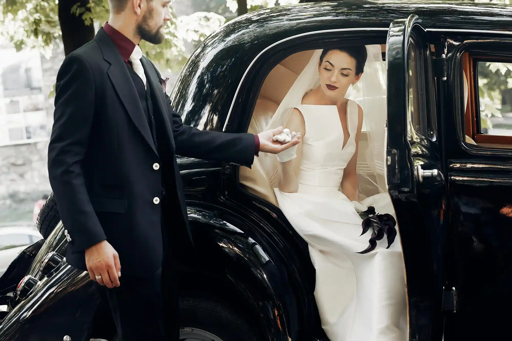 luxury executive shuttle loading wedding guests outside a waterfront Seattle venue, well-dressed family members smiling, Puget Sound and mountain backdrop